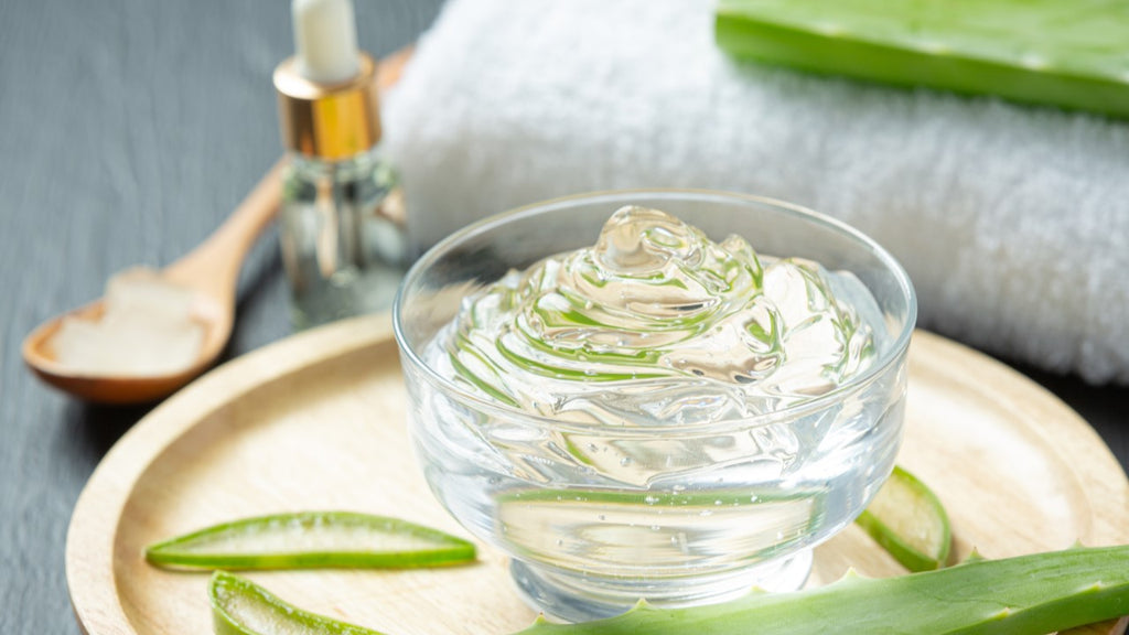 Aloe vera gel in a clear bowl with fresh aloe leaves, a quick healing tip for ripped skin after waxing.