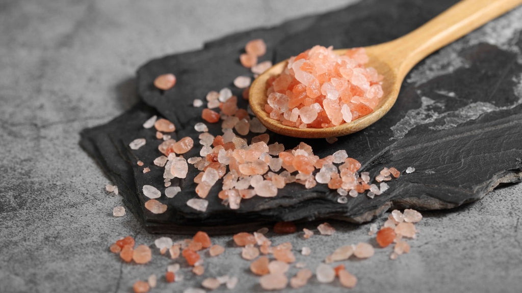 Alum crystals on a wooden spoon, a natural component used with rose water for hair removal.