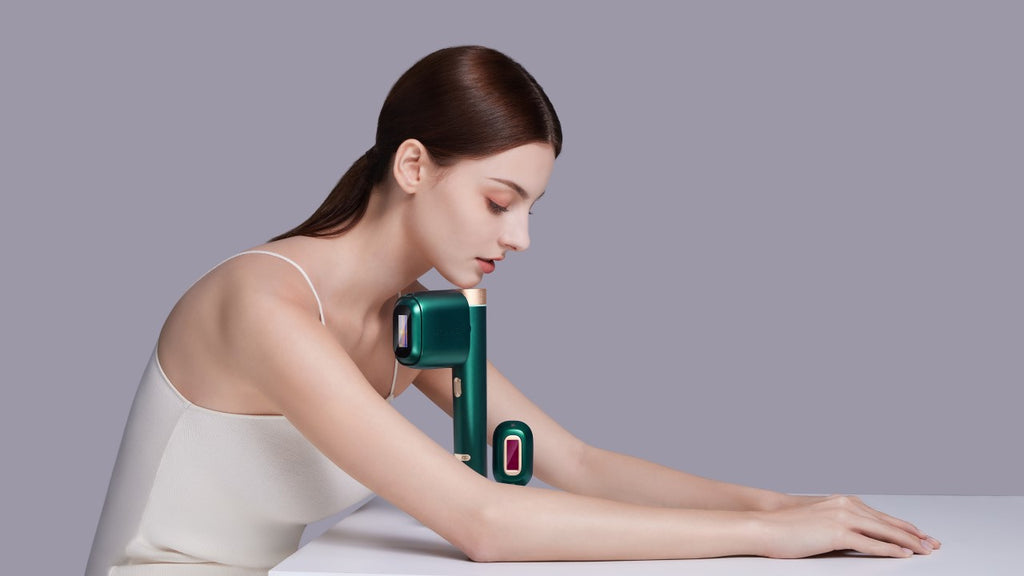 A modern beauty routine with a woman in a simple white top using an at home IPL hair removal device on her arm against a purple background.