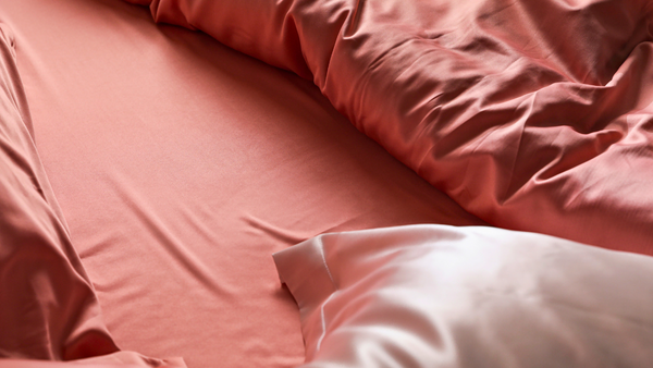 Pink silk pillowcases and red silk sheets