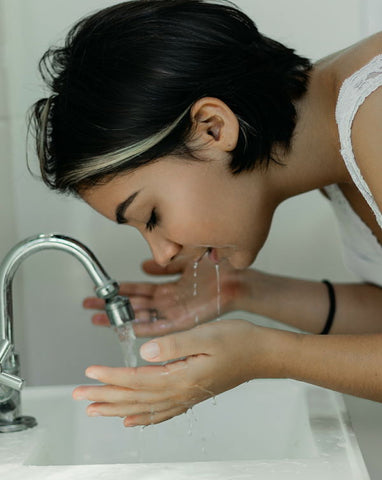 Woman washing her face.