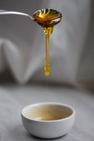 Honey dripping off a spoon