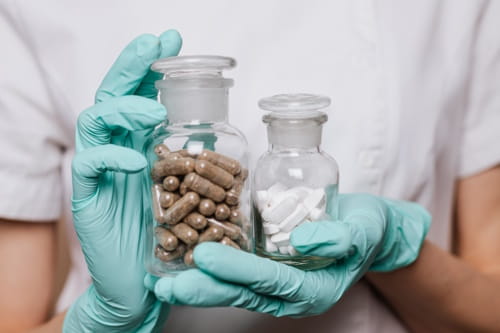 Doctor holding bottles of pills