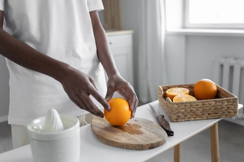 Person cutting orange