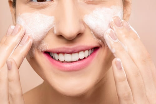 Woman applting skin care to her face