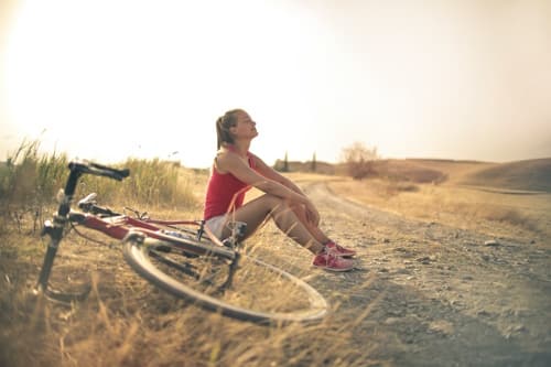 Woman enjoying the sun after biking