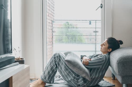 Depressed woman sitting on the floor