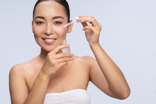 Woman holding a spot treatment serum