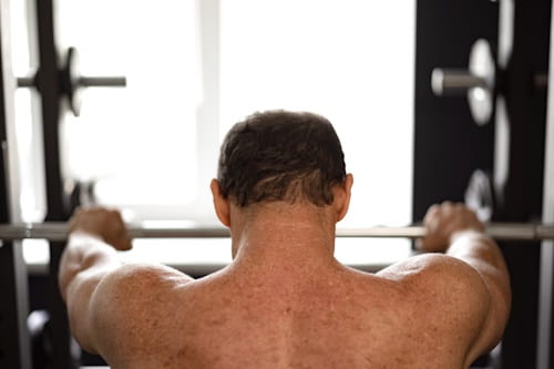 Back of a person working out in a gym