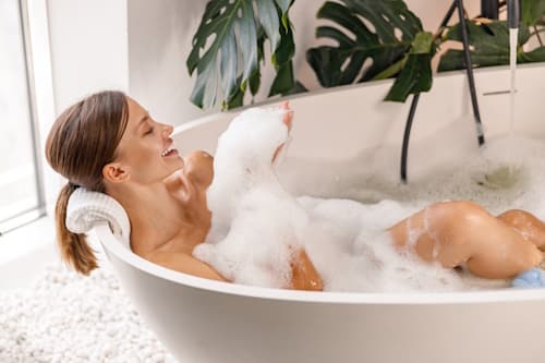 Happy woman taking a bath