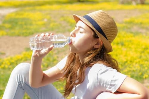 Woman drinking water on a sunny day