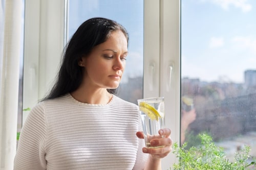 Woman drinking lemon water