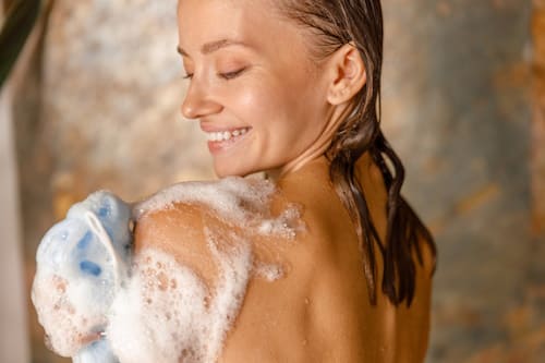 Caucasian woman happily showering