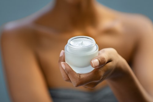 Woman holding acne cream