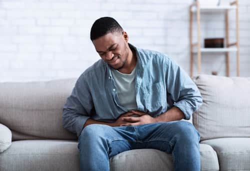 Young man having stomach aches