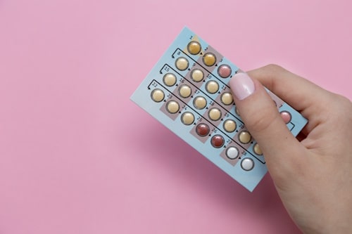 Hand holding oral contraceptives