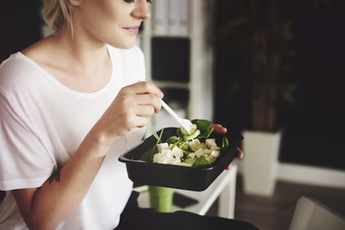 Woman eating vegetable salad