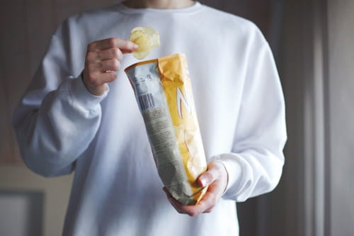 Man eating chips close up