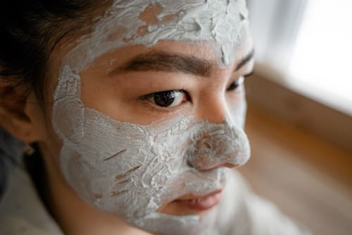 Asian woman with clay mask on face