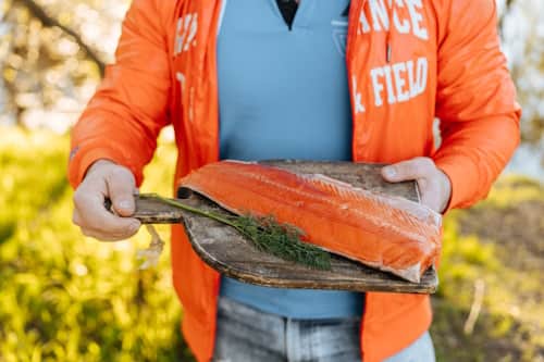 Man carrying prepared salmon dish