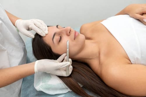 Hispanic woman getting dermaplaning treatment