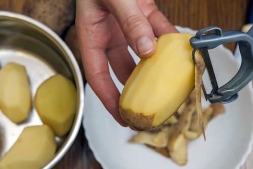 Close up of potato being peeled