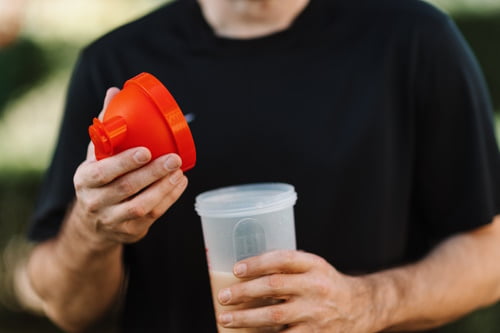 Man preparing a whey protein shake