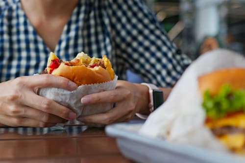 Person eating a hamburger