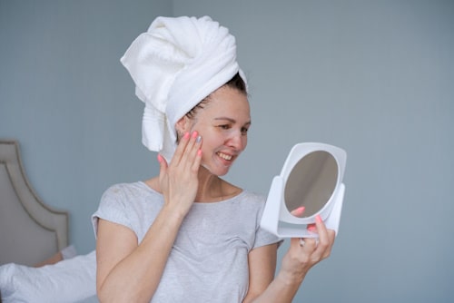 Woman treating her pustule acne