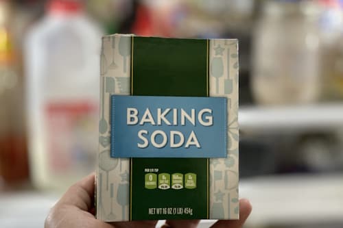 Hand holding box of baking soda