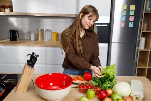 Woman preparing healthy meal with vegetables