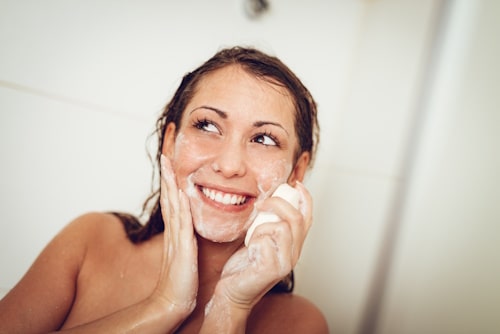 Woman happy washing face