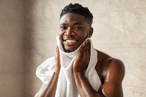 African American man wiping ears