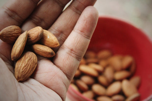 Closed up handful of almond nuts