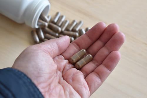 Berberine pills on persons hand