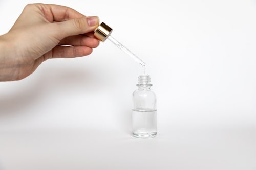 Hyaluronic acid drop falls from cosmetic pipette