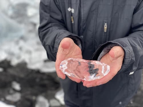 Person holding a huge chunk of ice