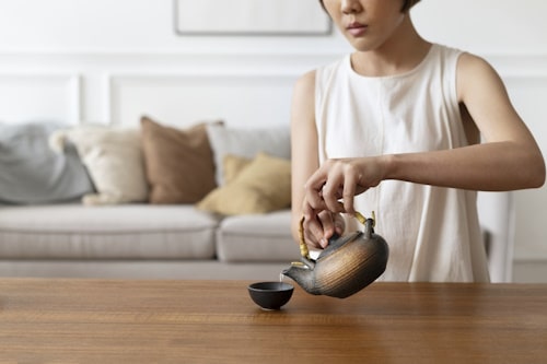 Japanese woman preparing matcha green tea 