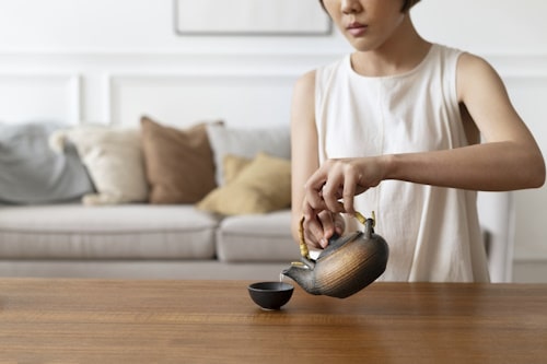 Asian woman pouring tea