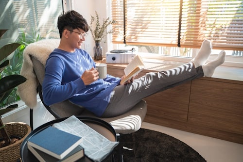 Guy relaxing with feet up and loose clothes