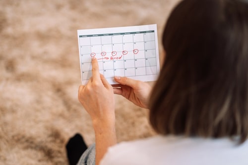 Lady looks at the days in the calendar menstrual