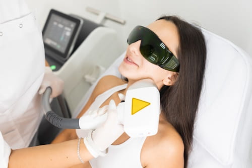 Woman getting laser hair removal on her face
