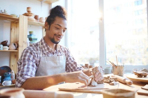 Photo of man creating toys