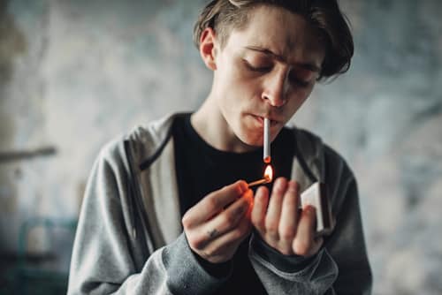 Person lighting a cigarette