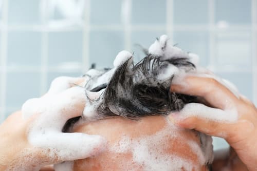 Man washing his hair with shampoo