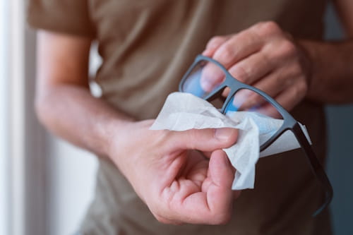 Close up of person cleaning glasses