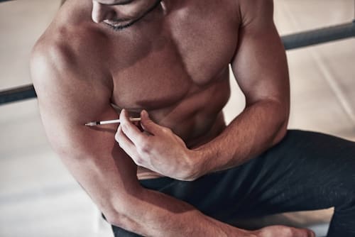 Muscular man getting testoserone injection