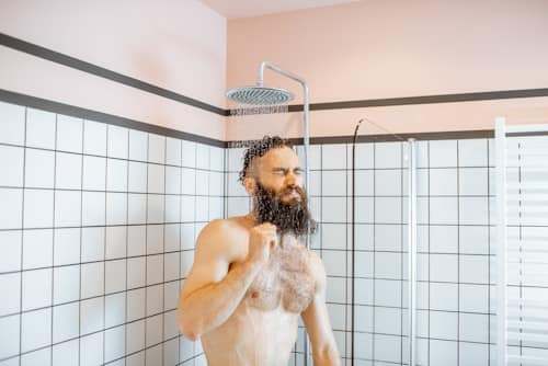 Man taking a cold shower