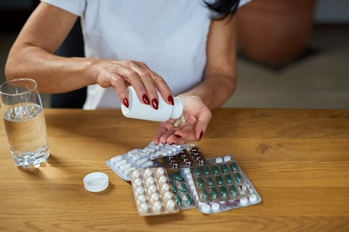 Mature woman having multiple antibiotic pills