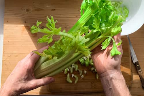 Image of person preparing to cook celery